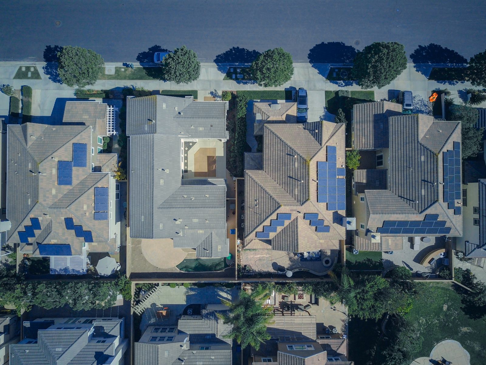 Aerial view of a row of homes with solar panels on their roofs